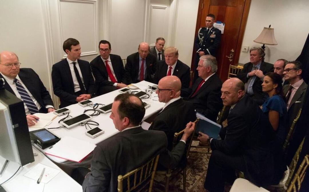 In this image provided by the White House, President Donald Trump receives a briefing on the Syria military strike from his national security team after the strike, at Mar-a-Lago in Palm Beach, Fla., Thursday, April 6, 2017.