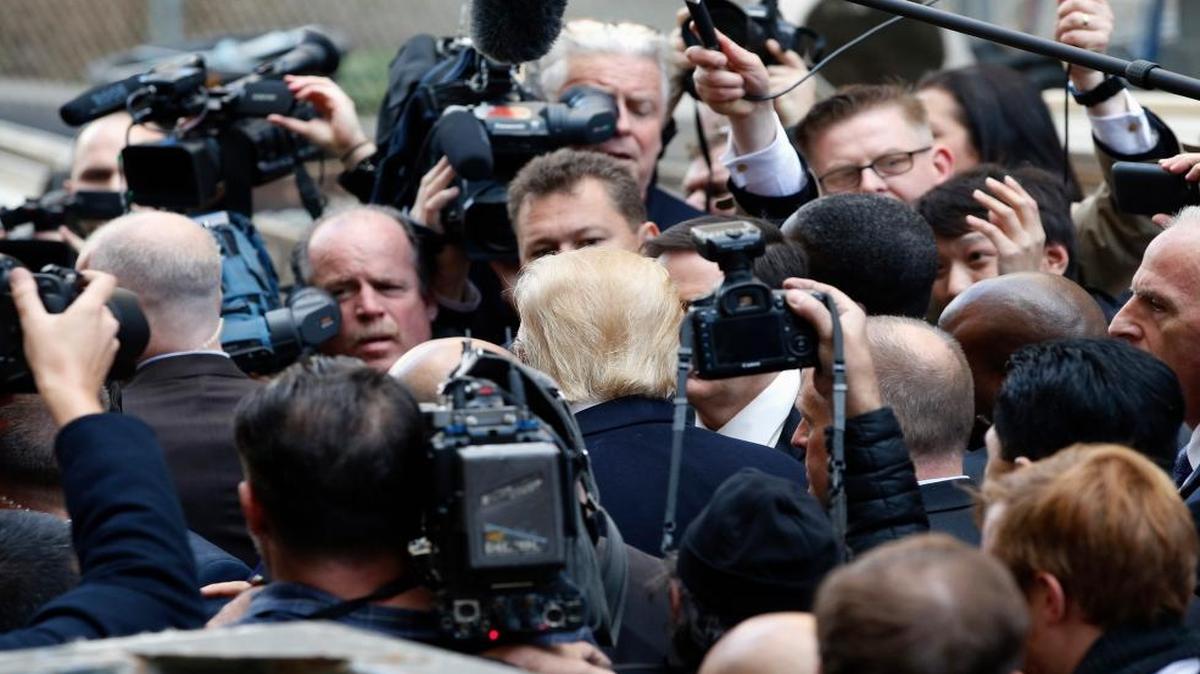 Republican presidential candidate Donald Trump, center, has banned some members of the media from his rallies.