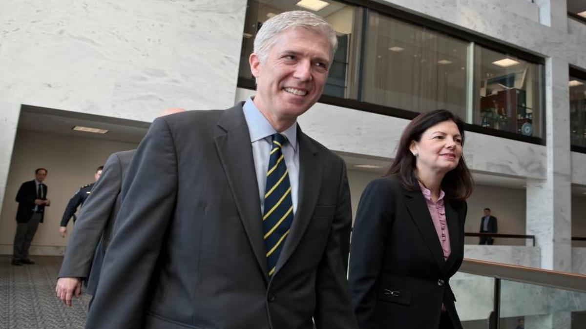 Supreme Court Justice nominee Neil Gorsuch is escorted by former New Hampshire Sen. Kelly Ayotte for meetings on Capitol Hill on Feb. 6.