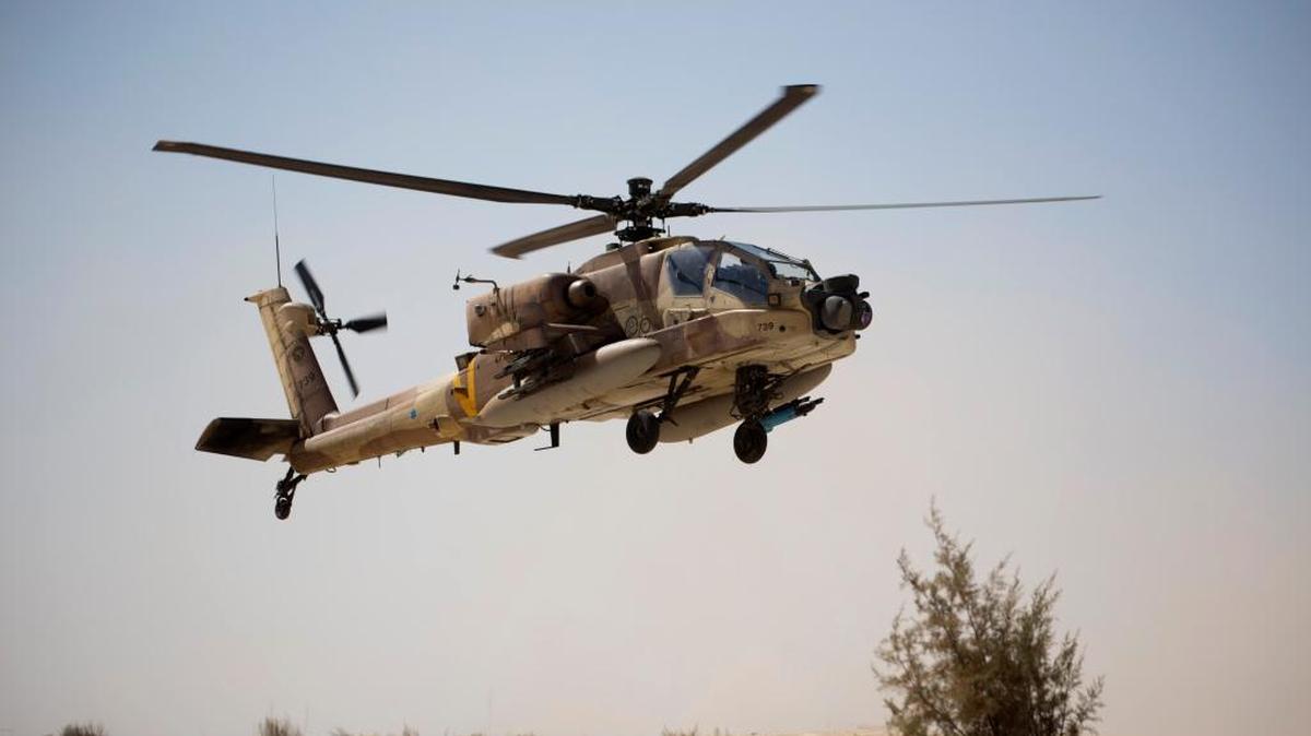 An Israeli Air Force Boeing AH-64 Apache attack helicopter from the 113th Squadron, also known as the Hornet Squadron, lands during a display for the foreign press in Ramon air force base near the Israeli town of Mitzpe Ramon, in the Negev desert, southern Israel, Monday, Oct. 21, 2013.