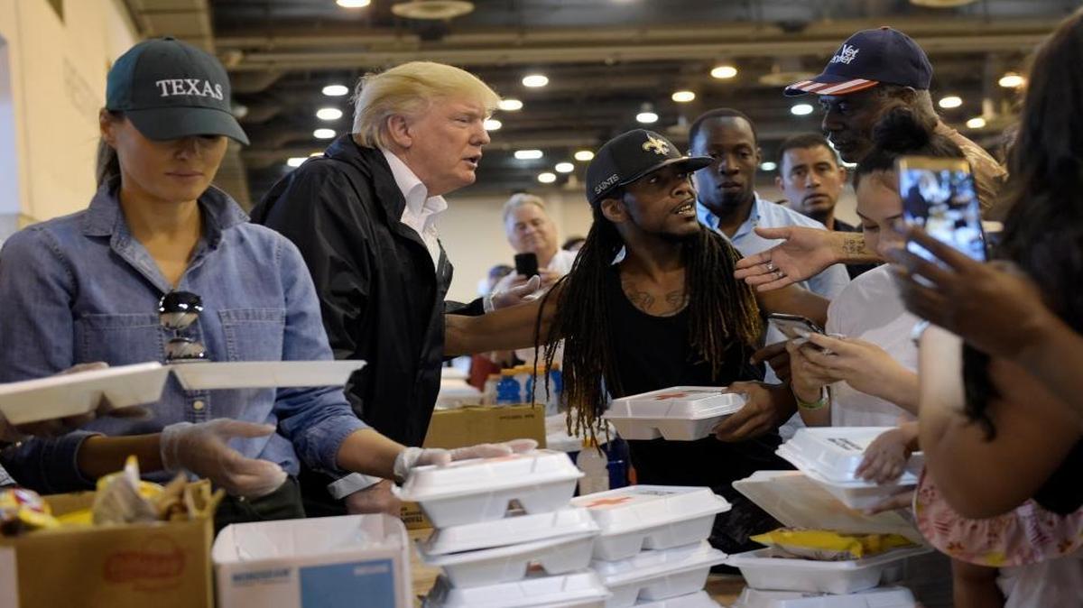 President Donald Trump and Melania Trump pass out food and meet people impacted by Hurricane Harvey during a visit to the NRG Center in Houston Saturday. It was his second trip to Texas in a week, and this time his first order of business was to meet with those affected by the record-setting rainfall and flooding.