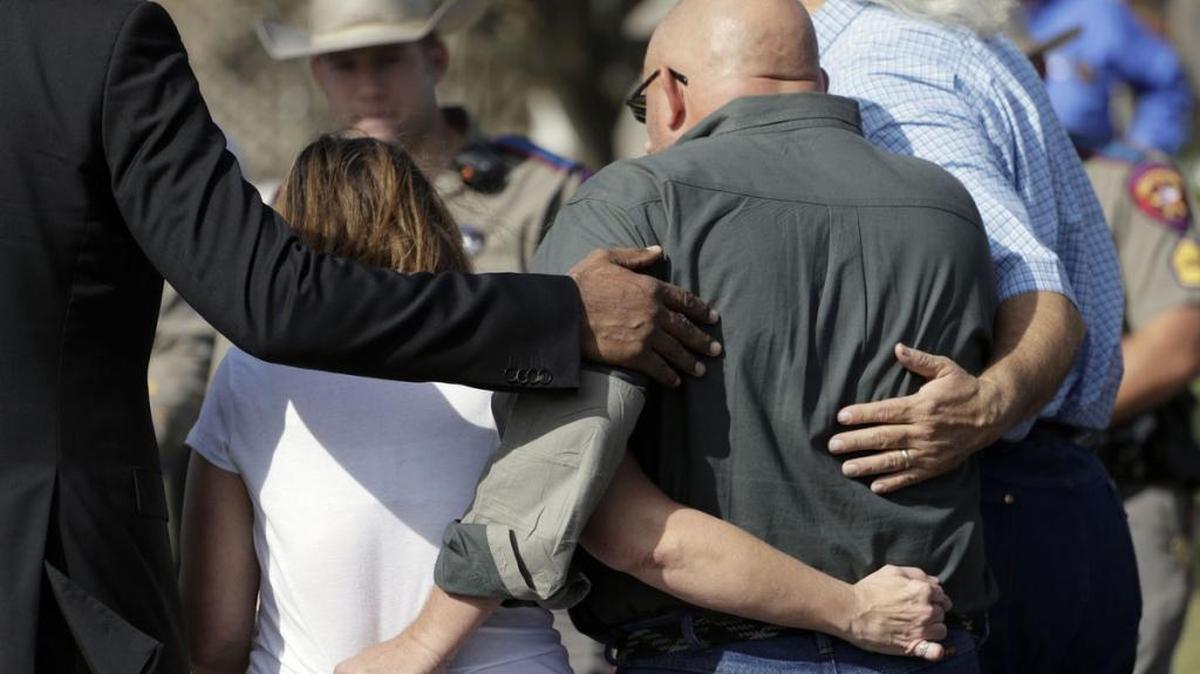 Pastor Frank Pomeroy and his wife, Sherri, are led away from a news conference Monday near the First Baptist Church of Sutherland Springs, Texas.