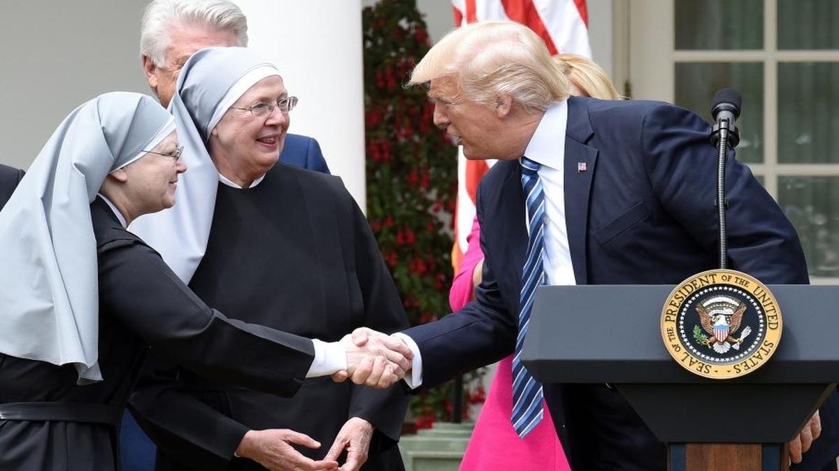 U.S. President Donald Trump greets the Little Sisters of the Poor before signing the Executive Order on Promoting Free Speech and Religious Liberty during a National Day of Prayer Event on Thursday, May 4, 2017 in the Rose Garden of the White House in Washington, D.C.