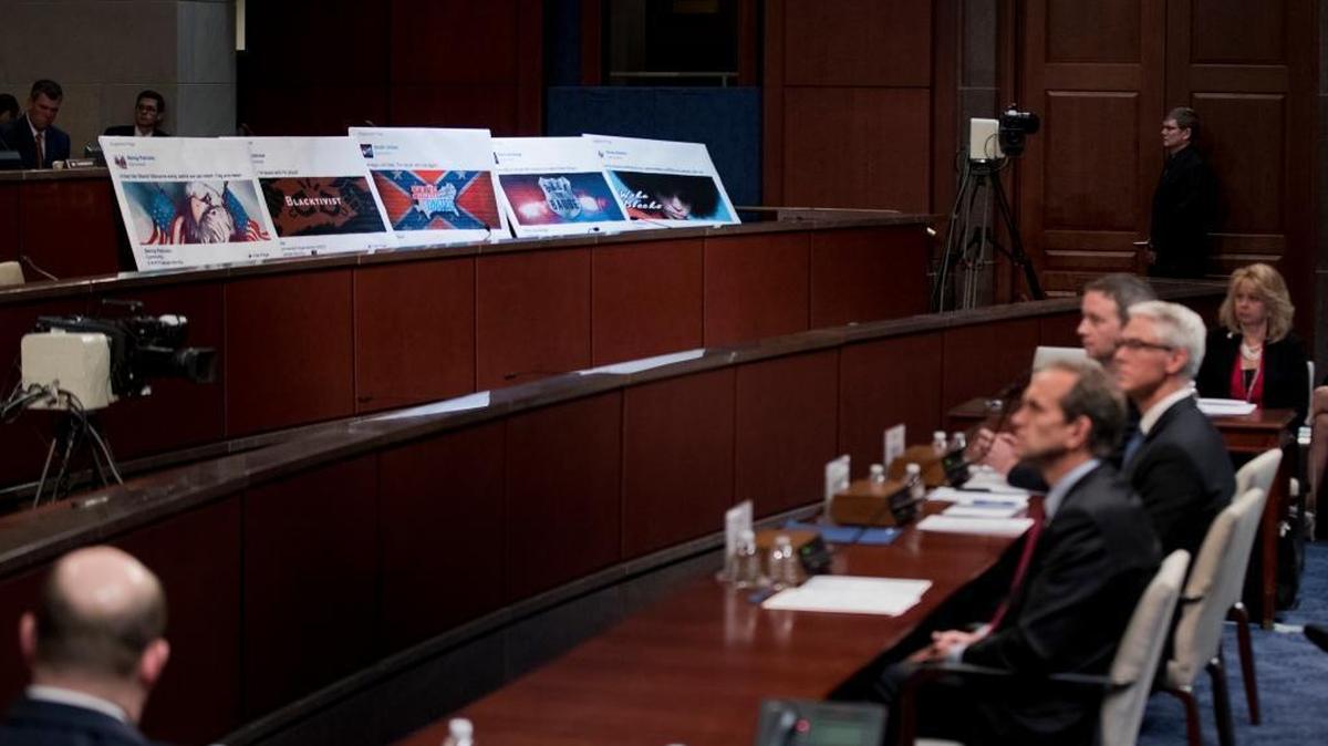 Facebook ads linked to a Russian effort to disrupt the American political process are displayed as, from left, Google’s Senior Vice President and General Counsel Kent Walker, Facebook’s General Counsel Colin Stretch, and Twitter’s Acting General Counsel Sean Edgett testify during a House Intelligence Committee hearing on Capitol Hill in Washington on Nov. 1.