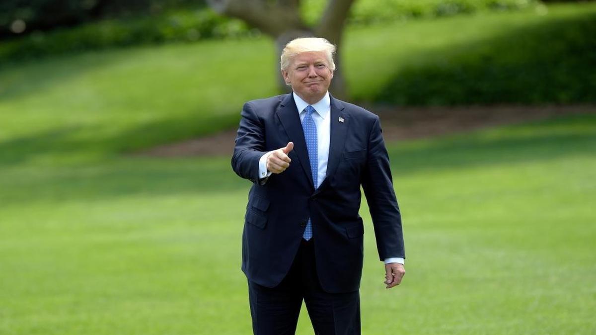 President Donald Trump gives a thumbs-up as he walks across the South Lawn of the White House in Washington, Friday, May 19, 2017, to board Marine One for a short trip to Andrews Air Force Base, Md. Trump was leaving for his first foreign trip, visiting Saudi Arabia, Israel, the Vatican and a pair of summits in Brussels and Sicily.