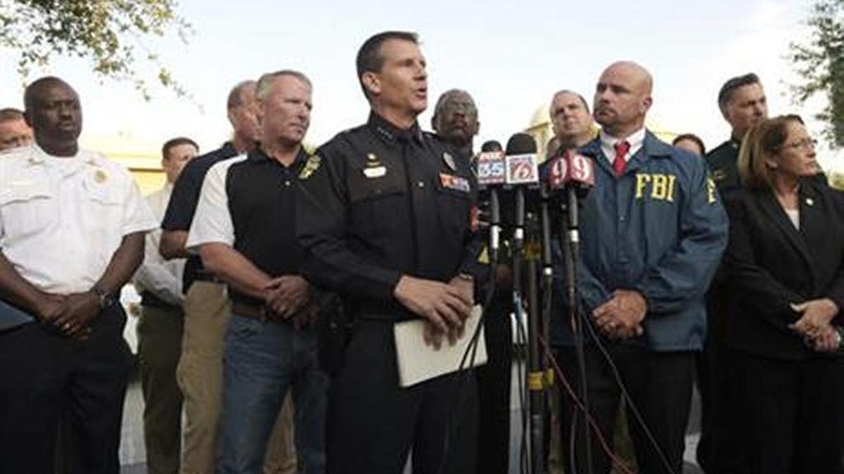 Orlando Police Chief John Mina, center, addresses reporters during a news conference about the Orlando nightclub shootings.