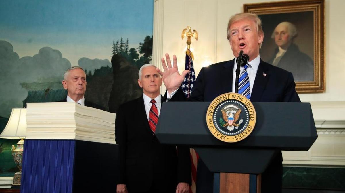 President Donald Trump with, Defense Secretary Jim Mattis, left, and Vice President Mike Pence, speaks in the Diplomatic Room of the White House in Washington, Friday, March 23, 2018, about the $1.3 trillion spending bill.