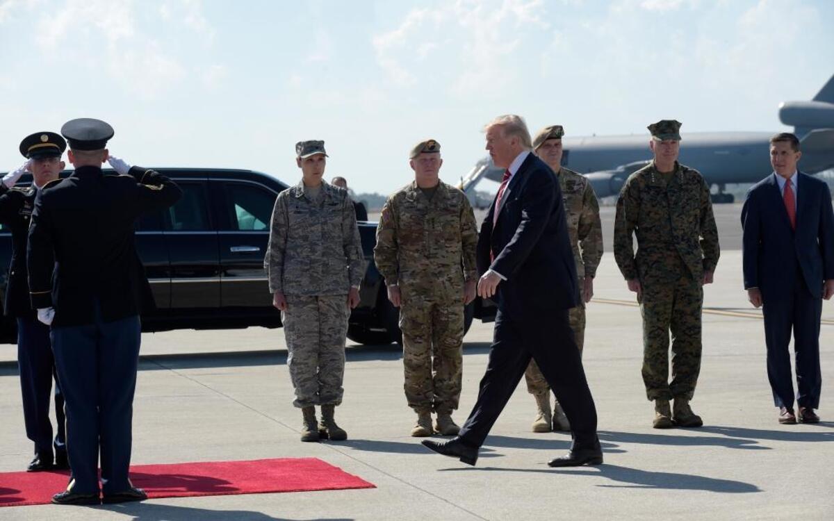 President Donald Trump arrives via Air Force One at MacDill Air Force Base in Tampa, Fla., Monday, Feb. 6, 2017. He stopped for a visit to the headquarters for U.S. Central Command and U.S. Special Operations Command before returning to Washington. National Security Adviser Michael Flynn is at right, and Joint Chiefs Chairman Gen. Joseph Dunford is second from right.