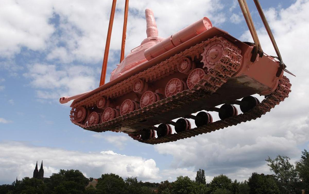 A tank painted pink and with a finger making an obscene gesture fitted onto of its turret, is transported onto a boat to be displayed on the Vltava river to commemorate the 20th anniversary of the withdrawal of Soviet troops from Czechoslovakia downtown Prague, Czech Republic, Monday, June 20, 2011.