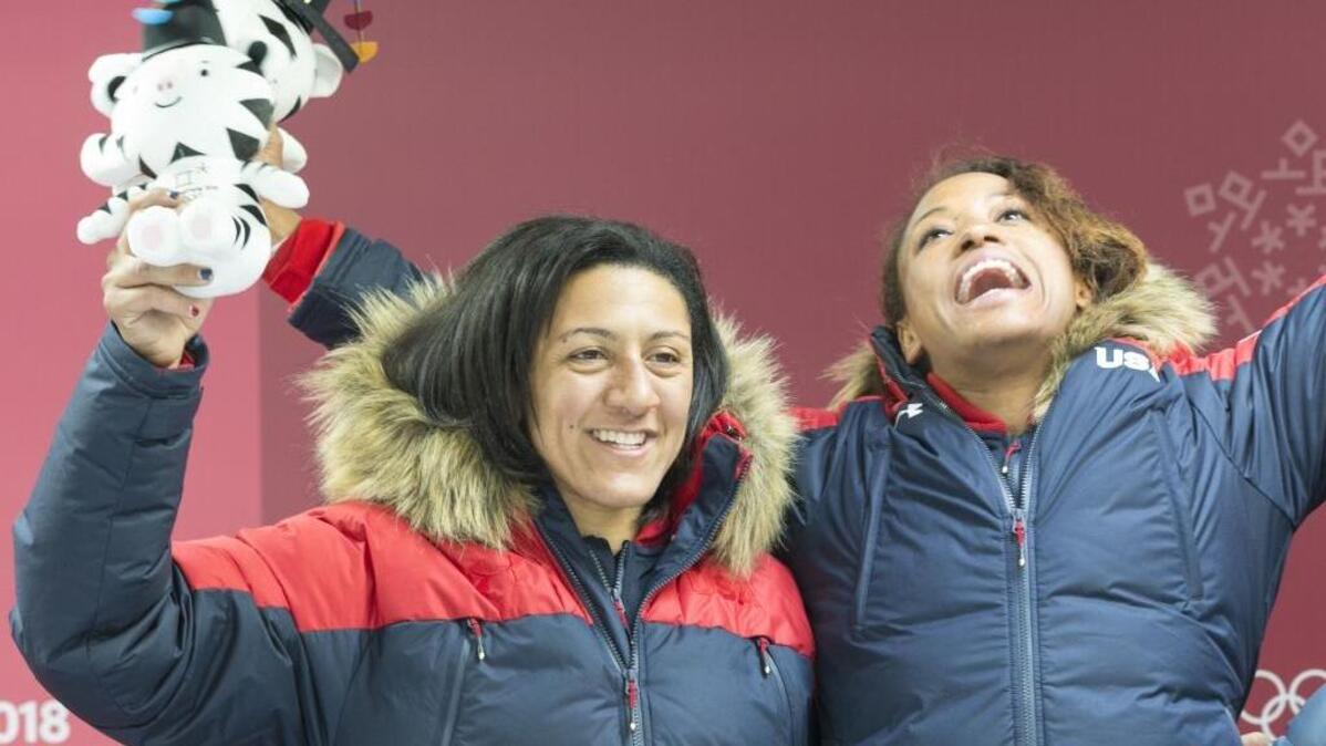 U.S. Olympic bobsledders Elana Meyers Taylor, left, and Lauren Gibbs celebrate a silver medal victory at the 2018 Winter Olympics.