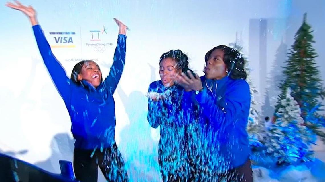 Nigerian boblsedders, from left, Ngozi Onwumere, Akuoma Omeoga and Seun Adigun play with fake snow during a media event in New York. The trio will represent Nigeria as the country fields its first-ever bobsled team at the Winter Olympics in Pyeongchang.