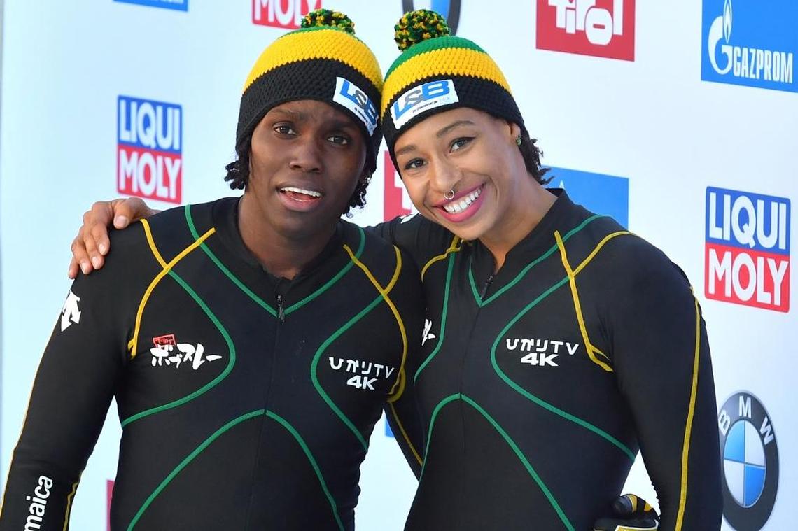 Jazmine Fenlator-Victorian and Carrie Russell of Jamaica pose after the women's bobsled World Cup race in Innsbruck.